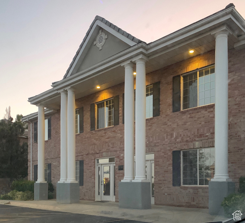 Property exterior at dusk with brick siding