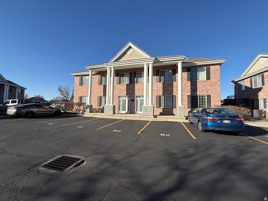 View of property featuring uncovered parking and a residential view