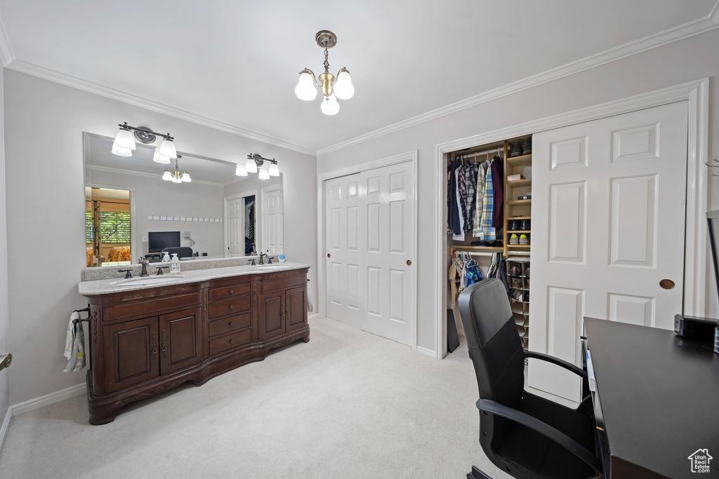 Office area with a sink, a chandelier, ornamental molding, light colored carpet, and baseboards
