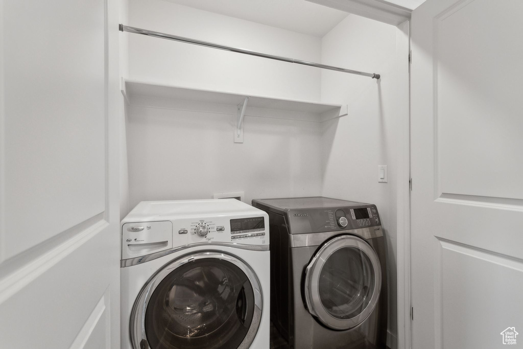 Clothes washing area featuring separate washer and dryer