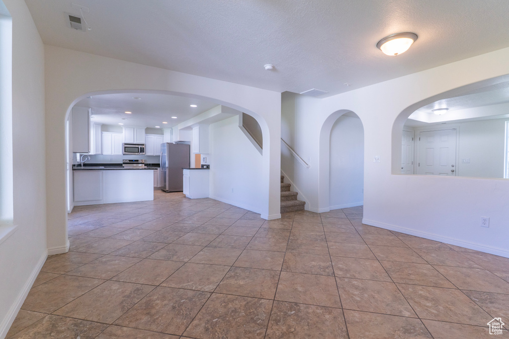 Unfurnished room featuring recessed lighting, baseboards, and a sink