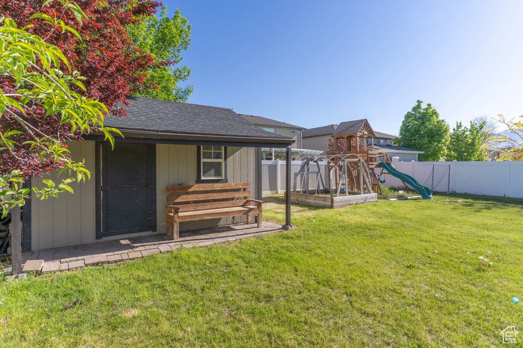 View of yard with a playground and an outdoor structure