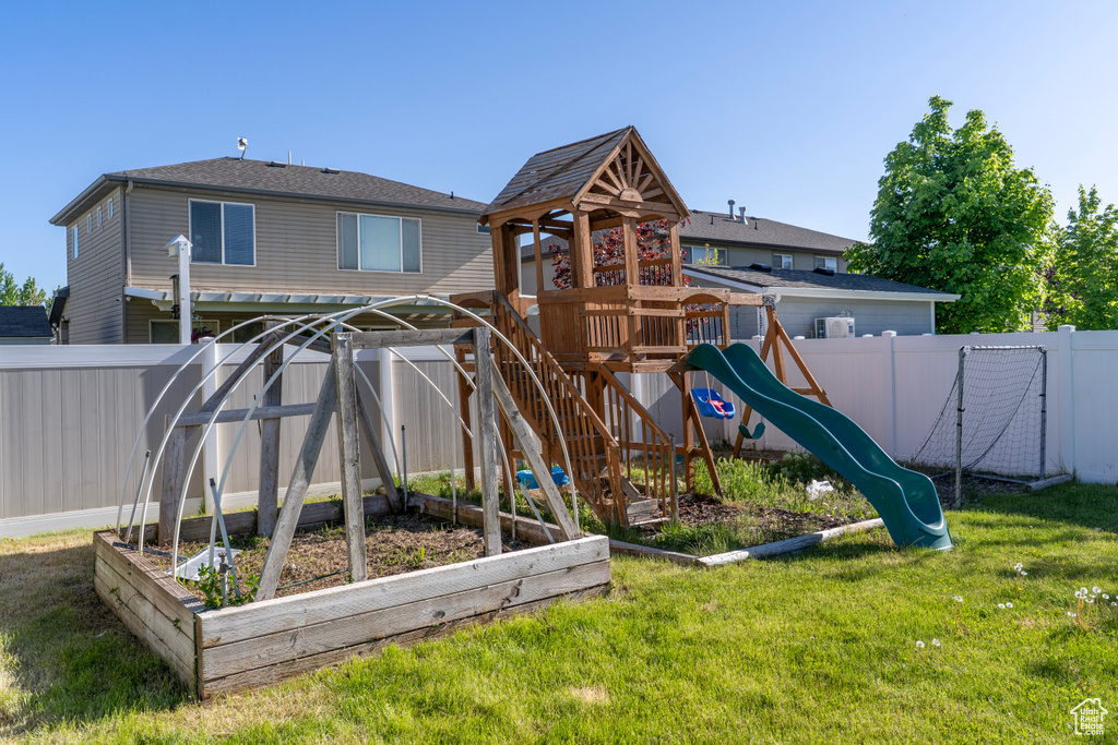 View of playground featuring a vegetable garden