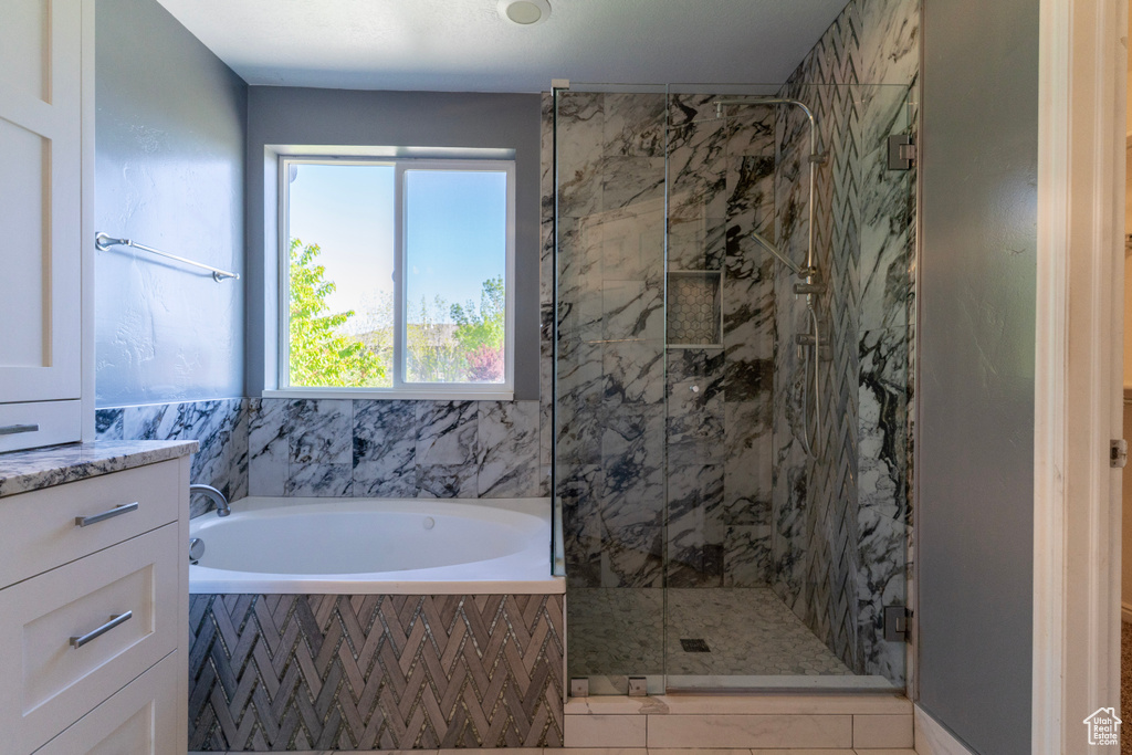 Bathroom with a shower stall and a garden tub