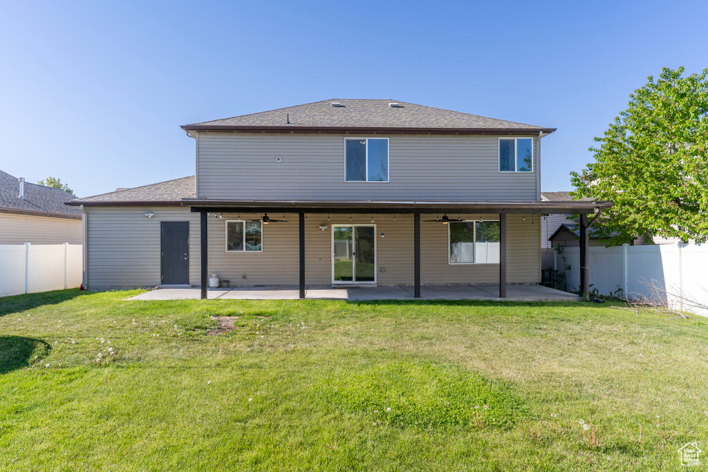 Back of house with ceiling fan and a patio area