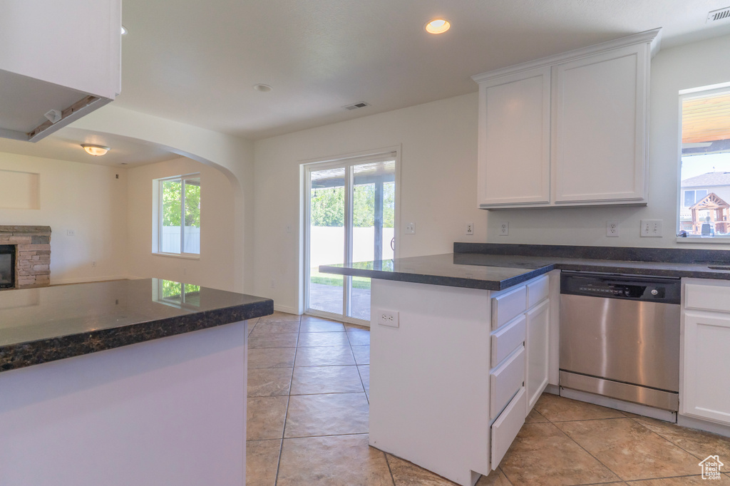 Kitchen with dishwasher, a peninsula, open floor plan, white cabinetry, and recessed lighting