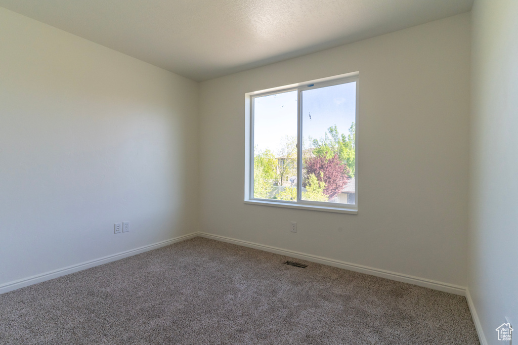 Unfurnished room with carpet flooring and baseboards