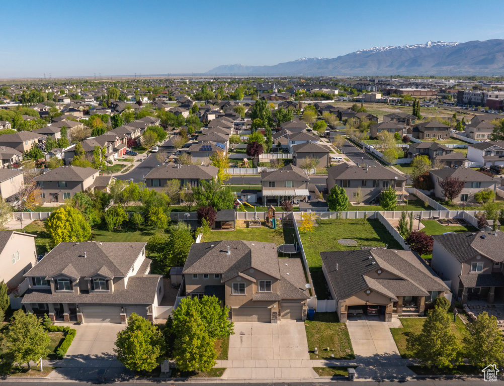 Aerial view of residential area featuring a mountainous background