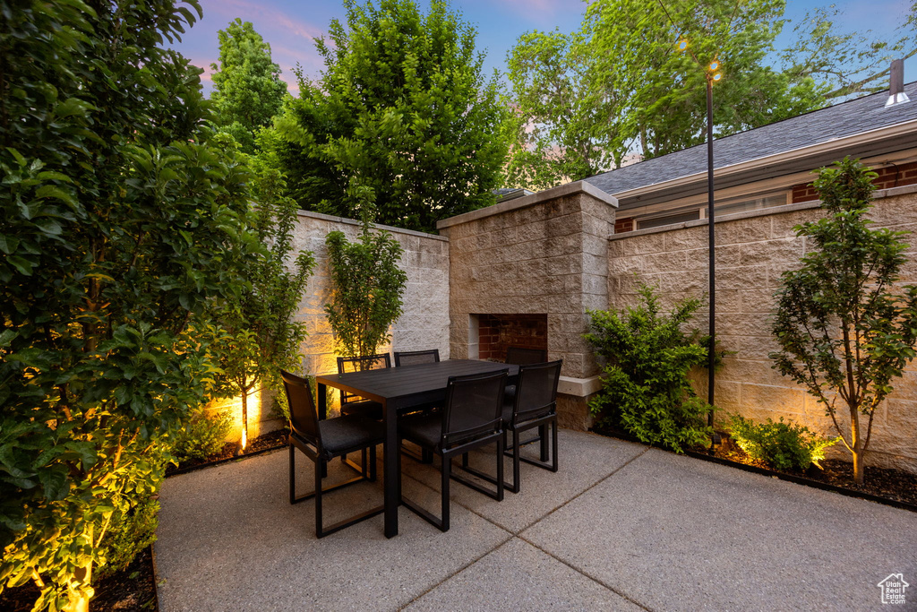 View of patio / terrace with outdoor dining area and an outdoor stone fireplace