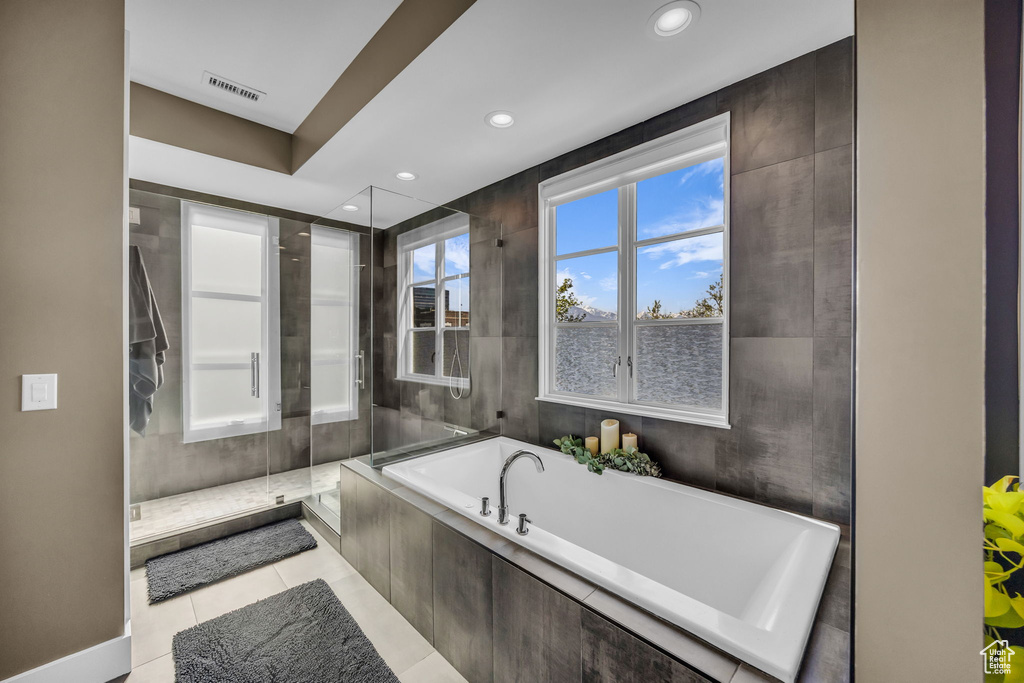 Bathroom with a bath, a shower stall, recessed lighting, and tile patterned floors