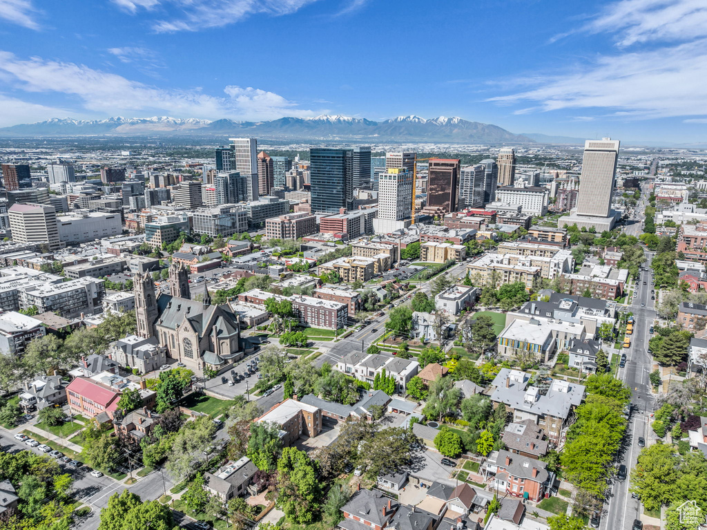 Aerial overview of property\\\'s location featuring a mountain backdrop and nearby urban area