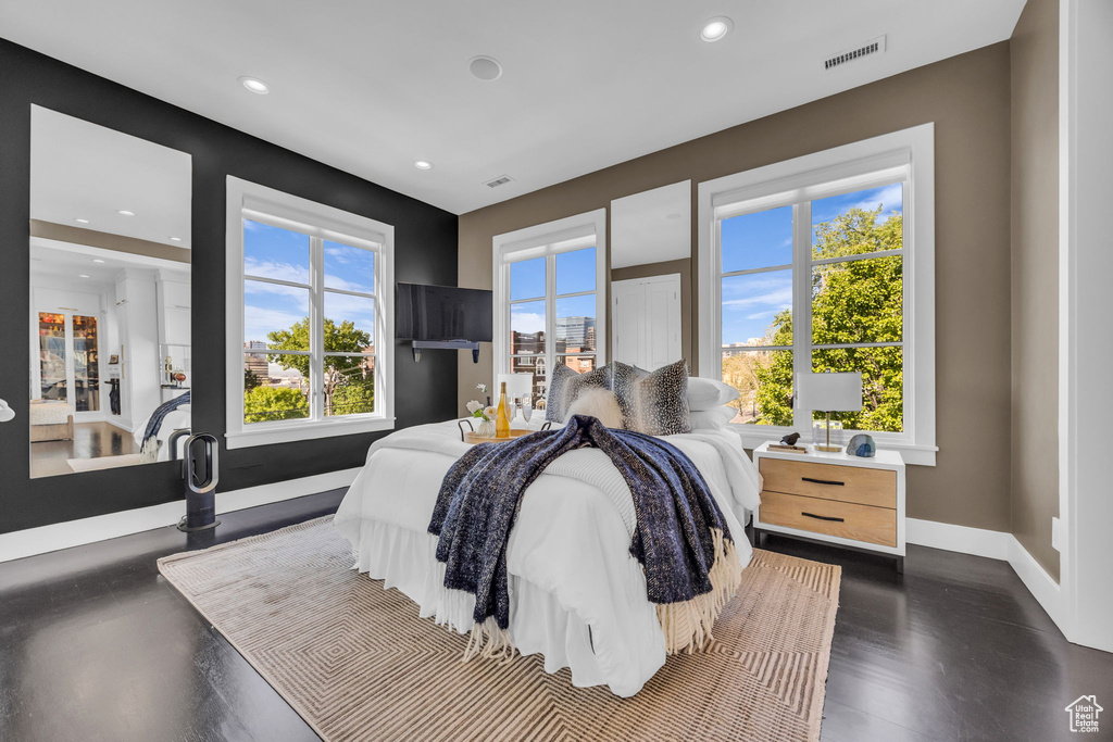 Bedroom with recessed lighting, multiple windows, and baseboards