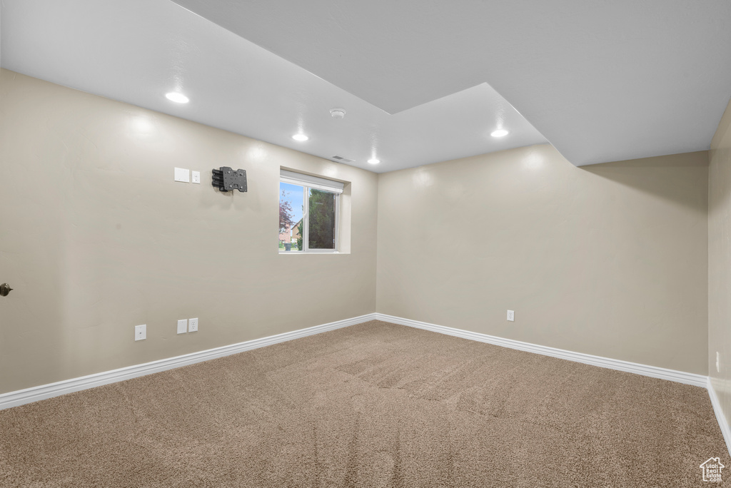 Basement featuring carpet flooring, baseboards, and recessed lighting