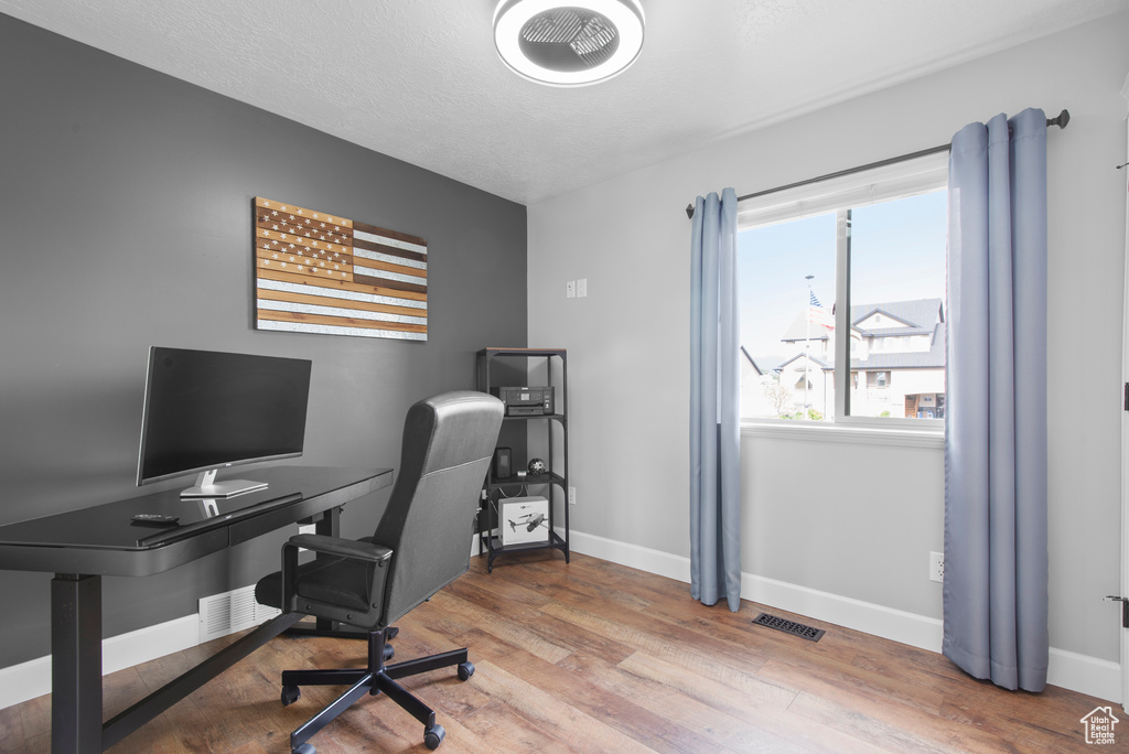 Office space featuring baseboards and wood finished floors