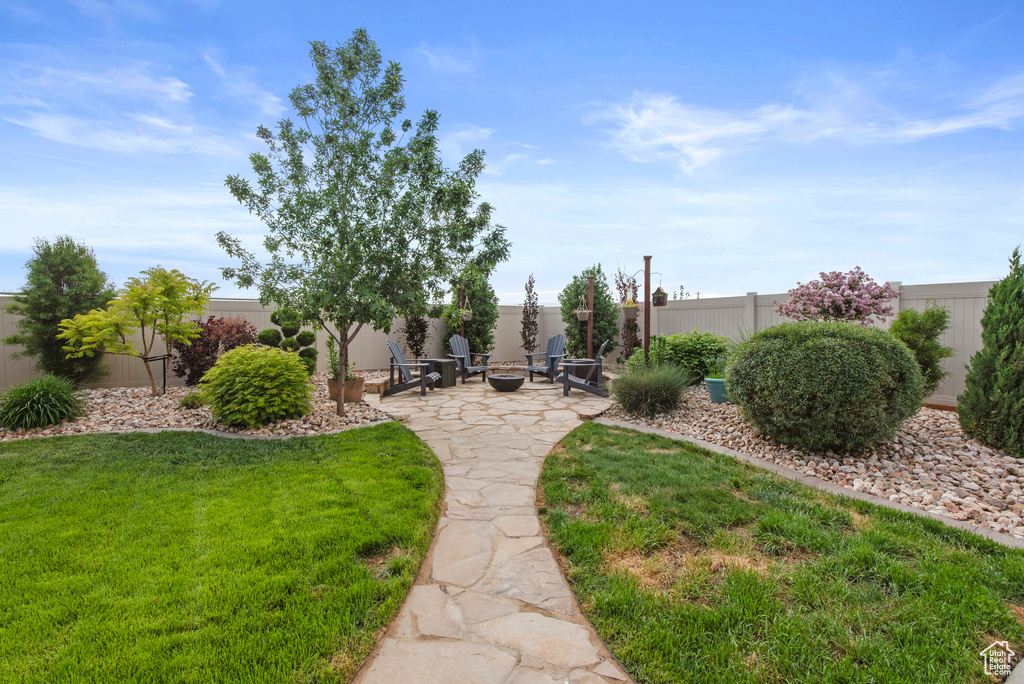 View of yard featuring a patio and a fire pit