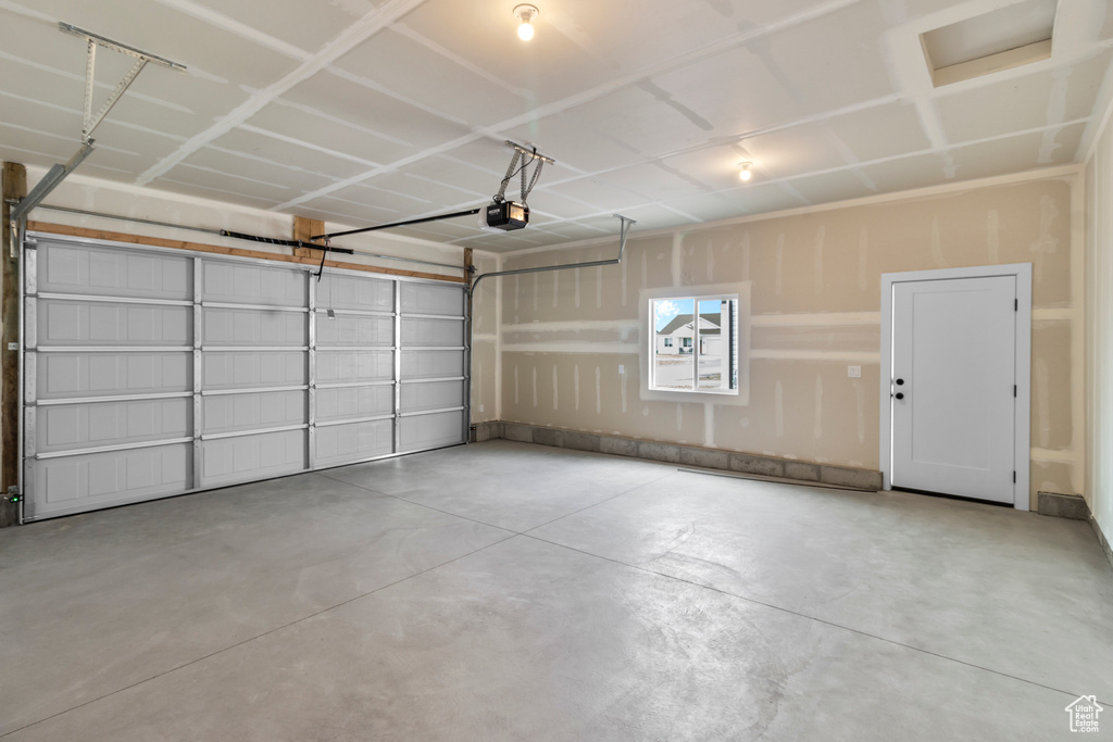 Garage featuring a garage door opener