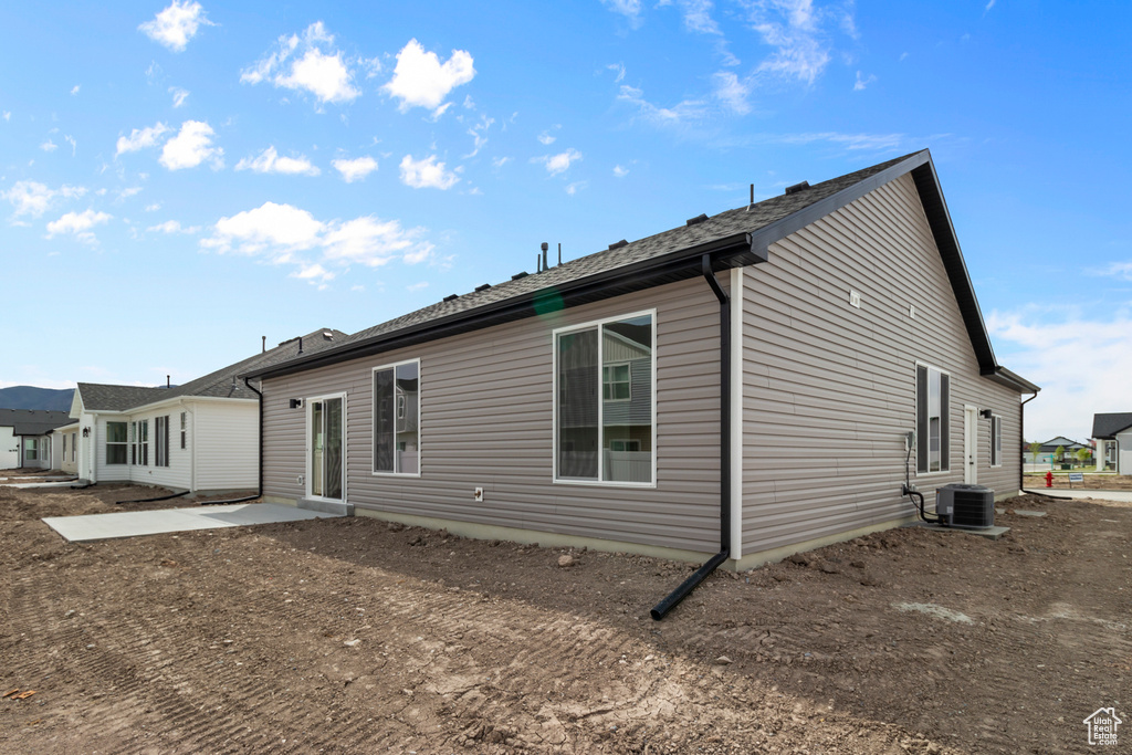 Rear view of house featuring central AC unit