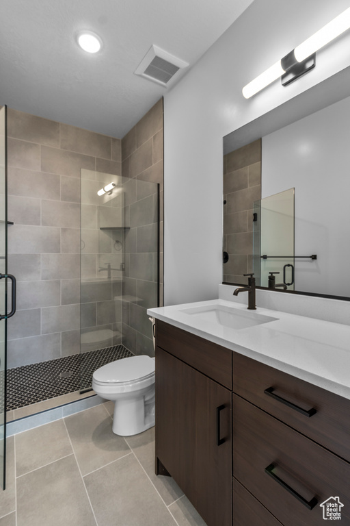 Full bathroom featuring a shower stall, toilet, vanity, tile patterned floors, and recessed lighting