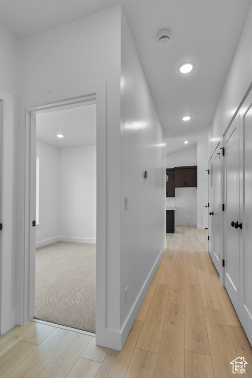 Corridor featuring wood finished floors, recessed lighting, and baseboards