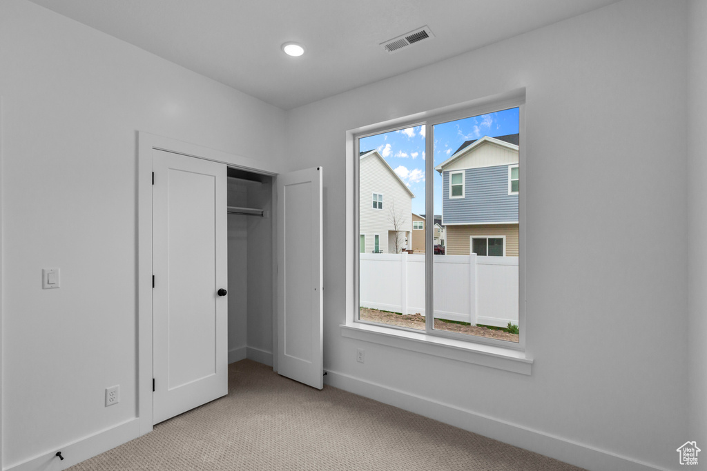 Unfurnished bedroom with carpet floors, baseboards, recessed lighting, and a closet