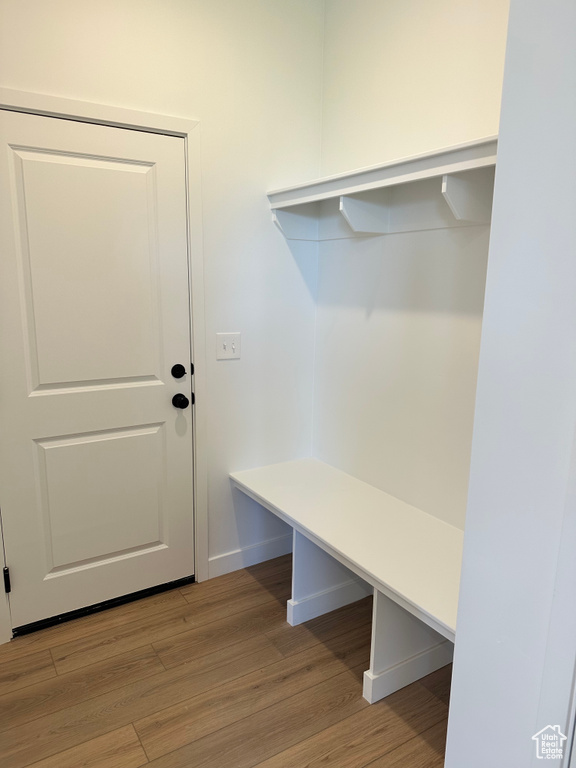 Mudroom with light wood-style flooring and baseboards