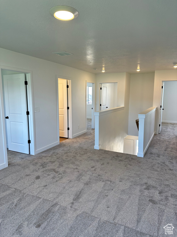Empty room with carpet flooring and baseboards