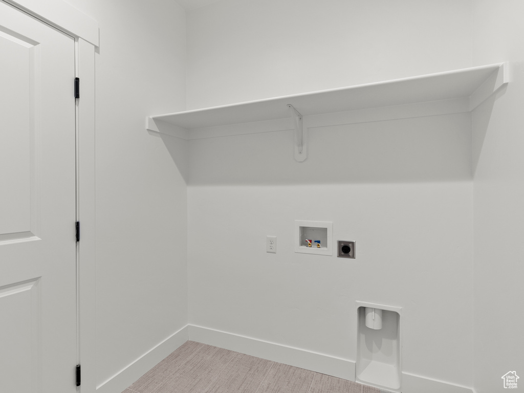 Washroom featuring hookup for a washing machine and hookup for an electric dryer