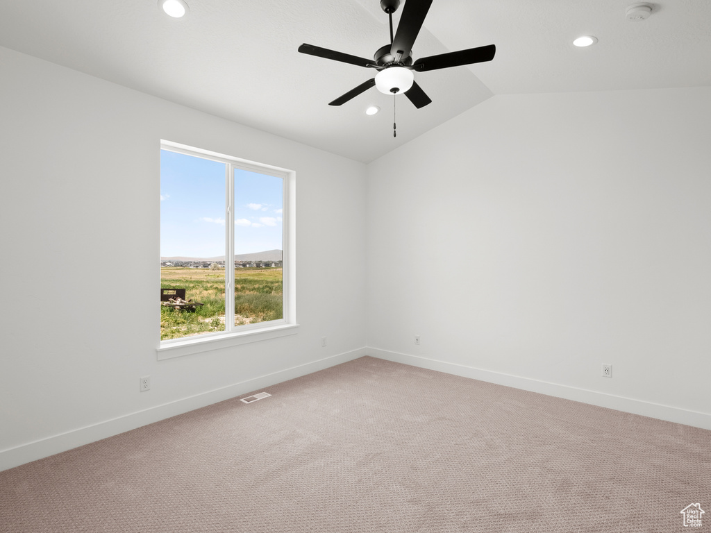 Spare room with recessed lighting, a ceiling fan, light carpet, lofted ceiling, and a smoke detector