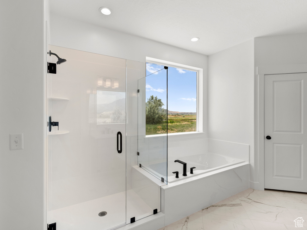 Bathroom with marble finish flooring, a bath, a shower stall, and recessed lighting