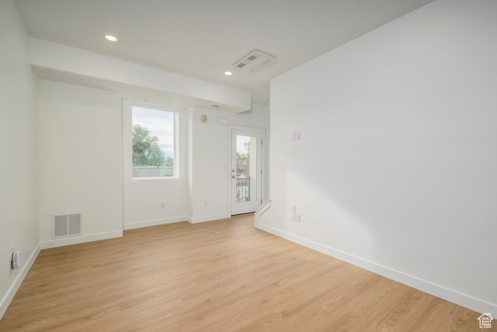 Unfurnished room with light wood-style flooring, baseboards, and recessed lighting