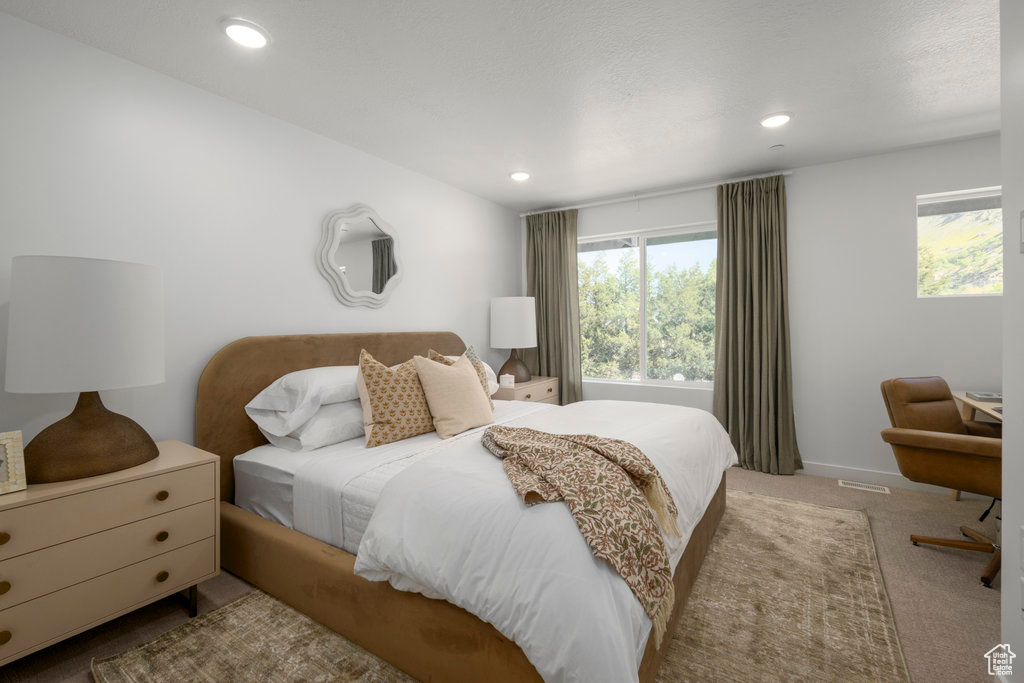 Carpeted bedroom with recessed lighting