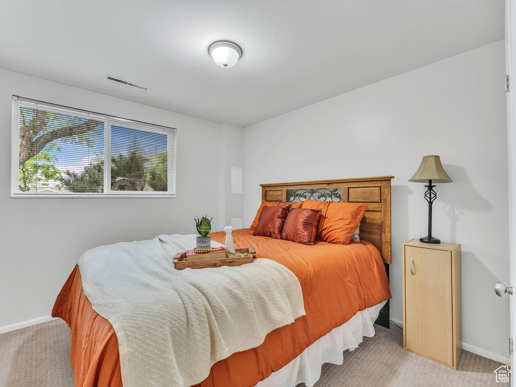 Bedroom featuring carpet floors and baseboards