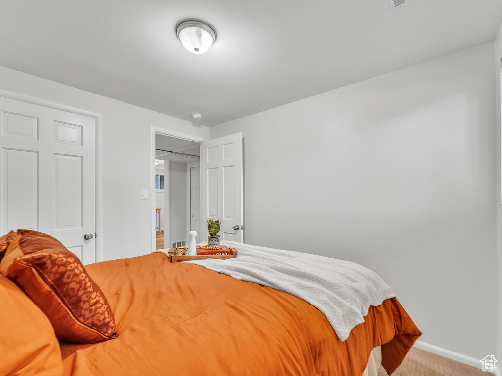 Carpeted bedroom with baseboards
