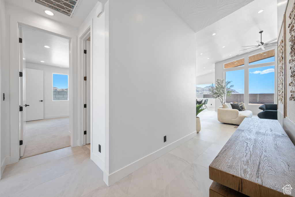 Corridor with recessed lighting and baseboards
