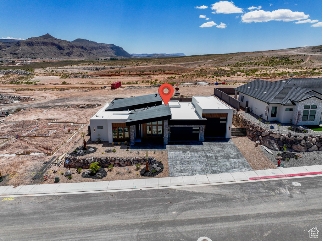 Aerial view of sparsely populated area with a desert landscape and a mountain backdrop