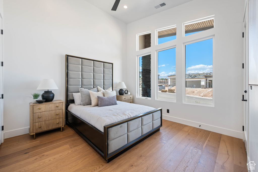 Bedroom featuring baseboards, light wood-type flooring, recessed lighting, and a ceiling fan