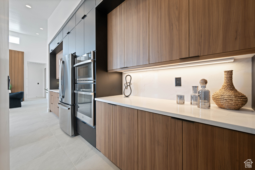 Kitchen with modern cabinets, stainless steel appliances, and light countertops