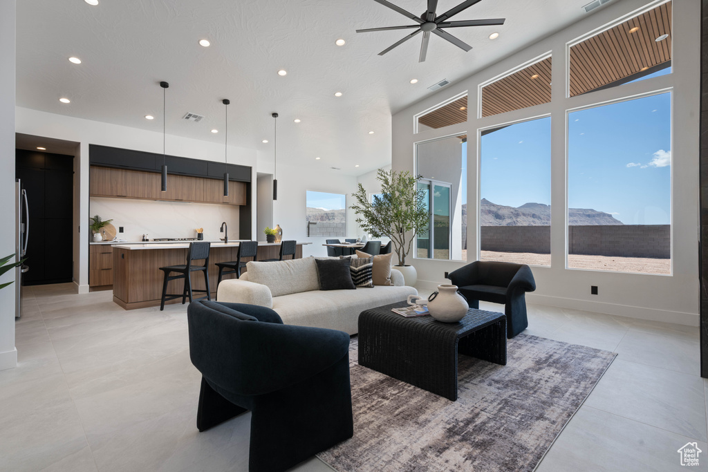 Living area featuring recessed lighting, a mountain view, and a ceiling fan