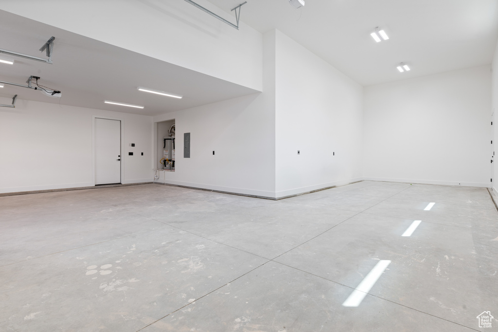 Garage with electric panel and baseboards