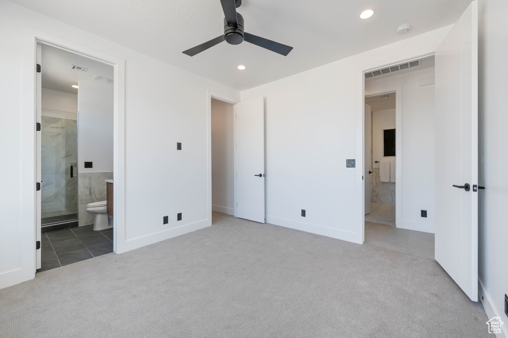Unfurnished bedroom featuring carpet, recessed lighting, ensuite bath, tile patterned floors, and baseboards