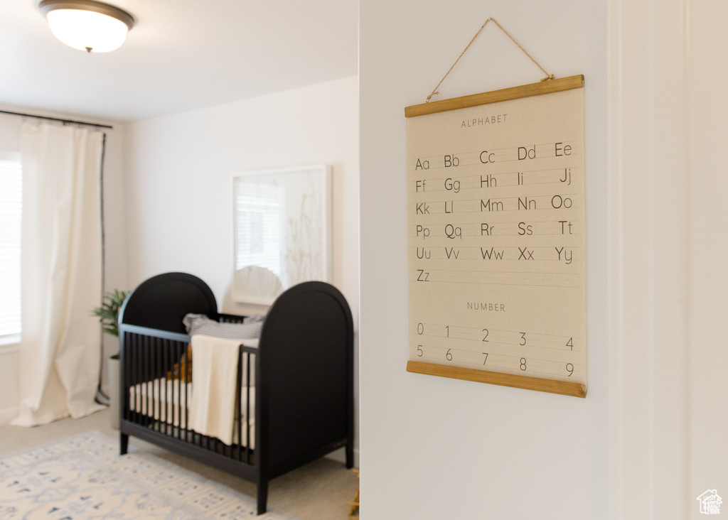 Bedroom featuring a nursery area