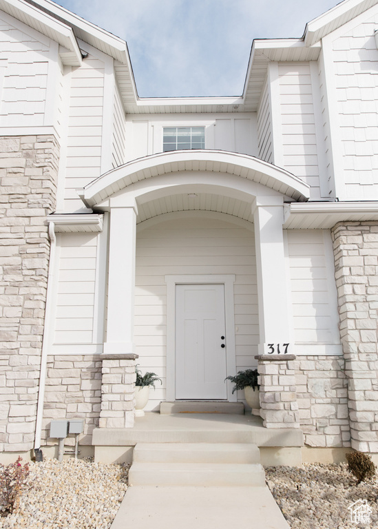 Property entrance featuring stone siding