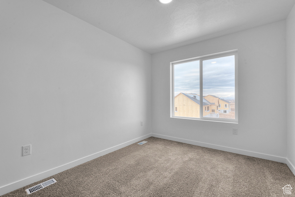 Unfurnished room with baseboards and carpet floors