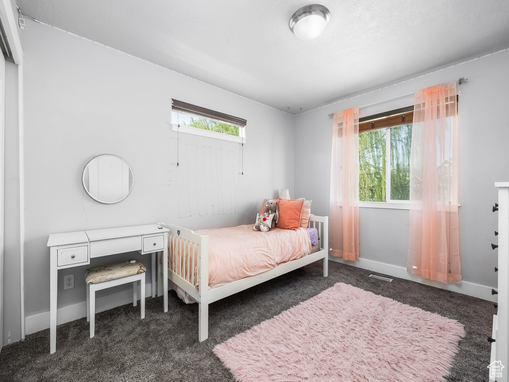Bedroom with carpet floors and baseboards