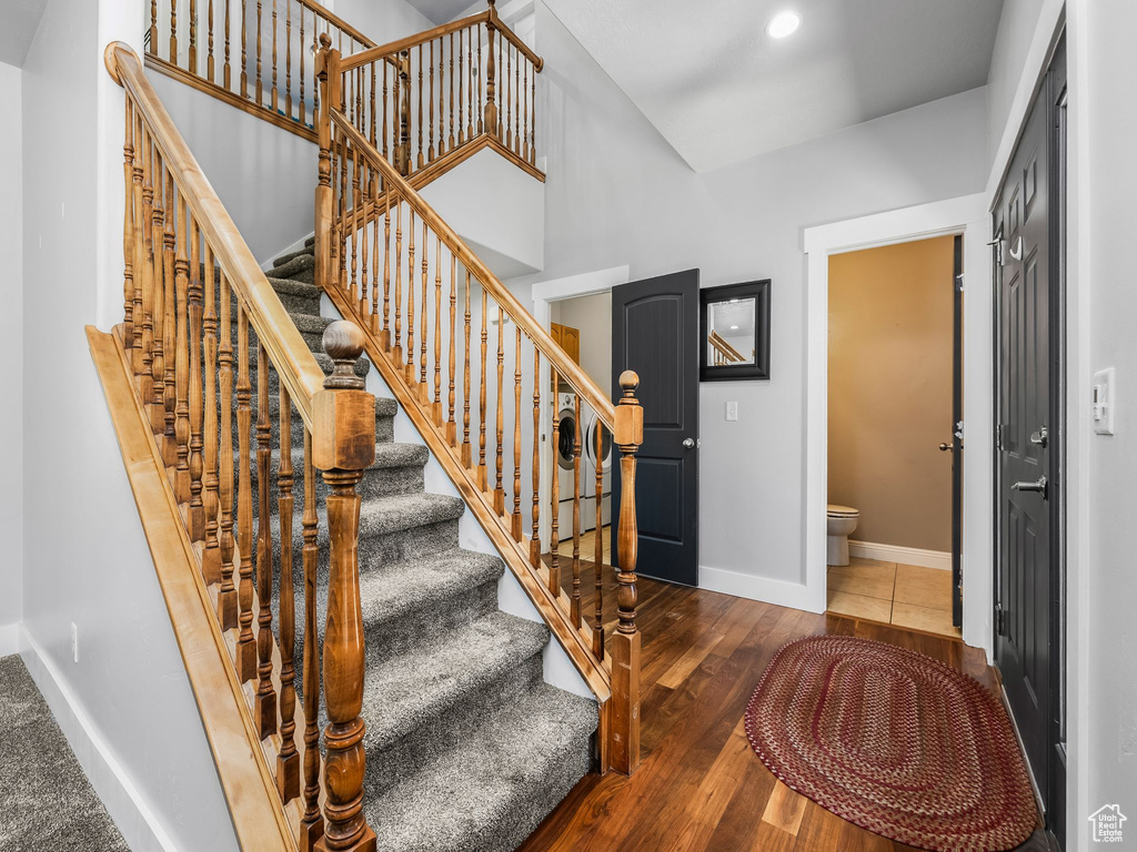 Staircase with baseboards and wood finished floors