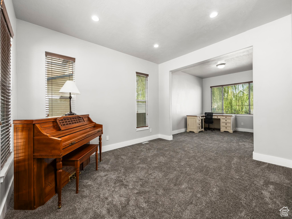 Living area featuring baseboards, dark colored carpet, an office area, and recessed lighting
