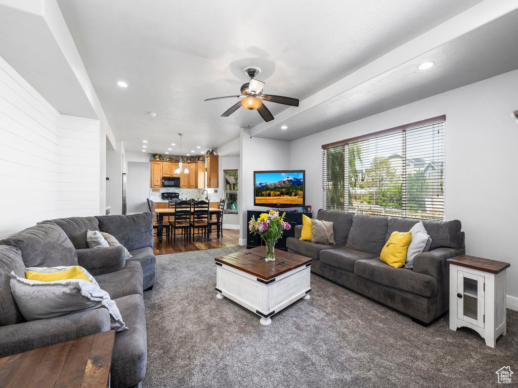 Living area featuring a ceiling fan, recessed lighting, baseboards, and wood finished floors