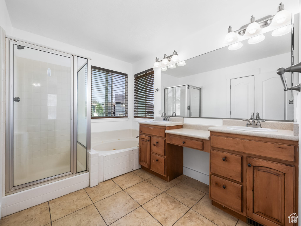 Bathroom with a shower stall, tile patterned floors, double vanity, and a jetted tub