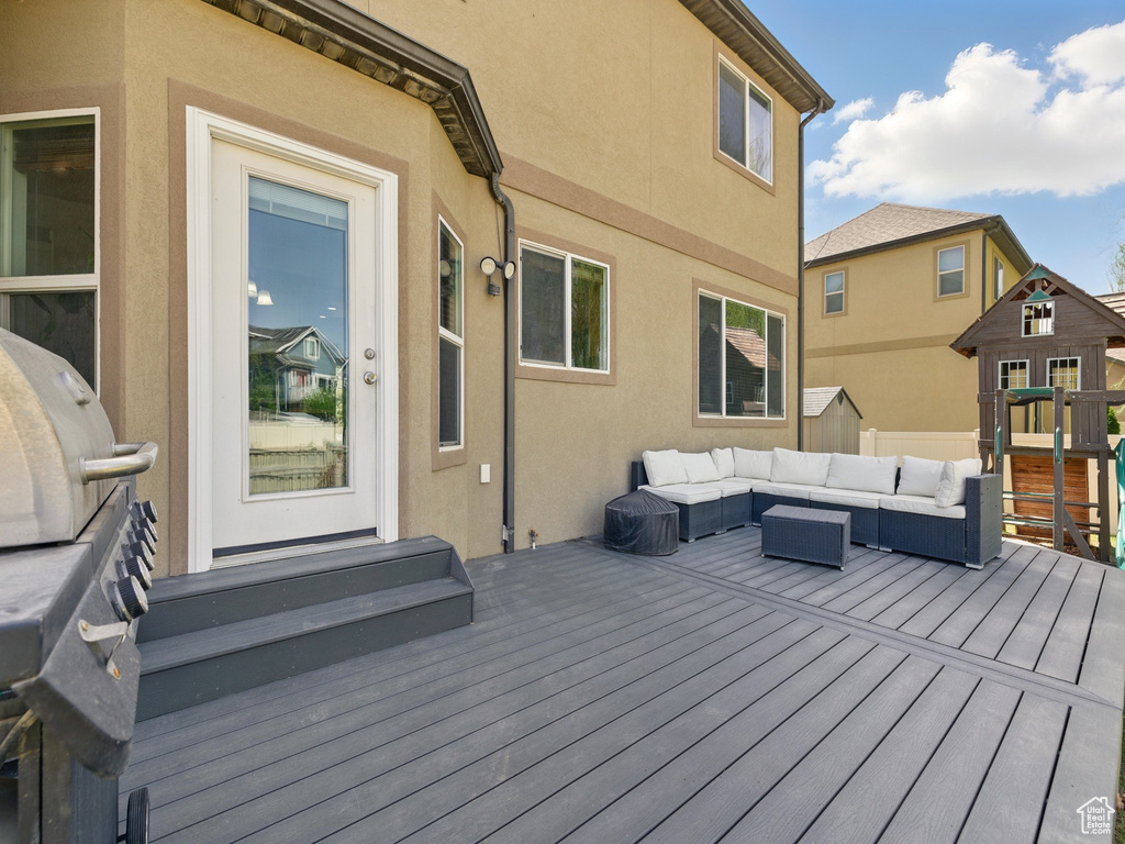 Wooden terrace featuring an outdoor living space