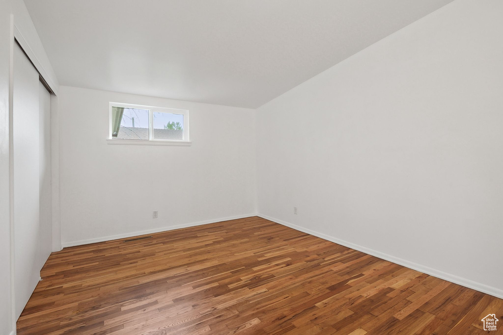 Empty room with wood finished floors and baseboards